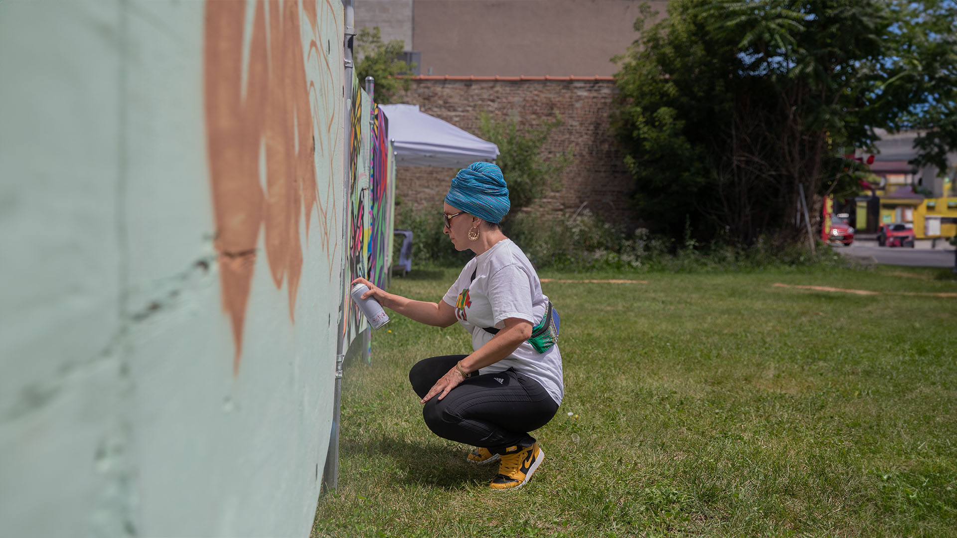 Jacinda Bullie painting a mural