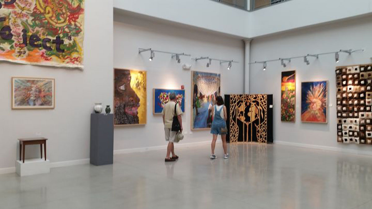 a gallery with folx looking at paintings