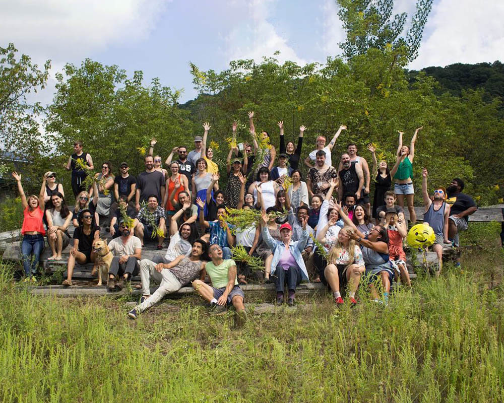 A group photo of artists in the landscape of Wisconsin